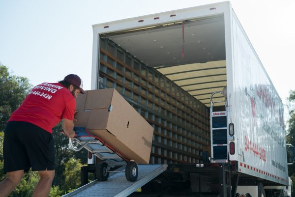 Dolly with boxes being loaded into truck